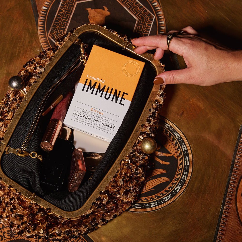 Leapfrog IMMUNE chewable tablets showing them in a handbag at a party to help with seasonal coughs and colds when in crwoded spaces